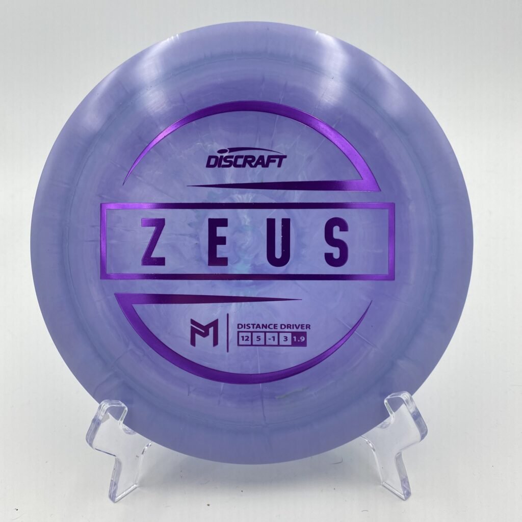 Main view of white Discraft Zeus in ESP plastic featuring a 6x Paul McBeth stamp.