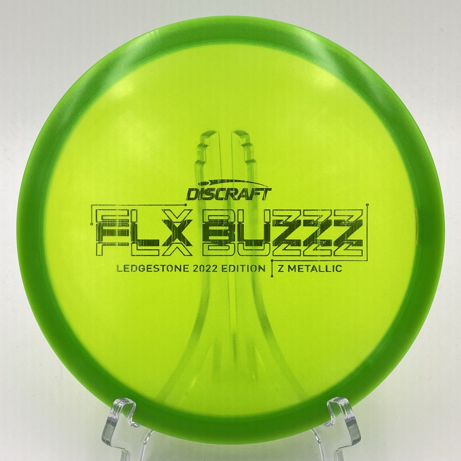 Top view of orange Discraft Z Metallic FLX Buzzz in 2022 Ledgestone Edition with silver foil stamp.