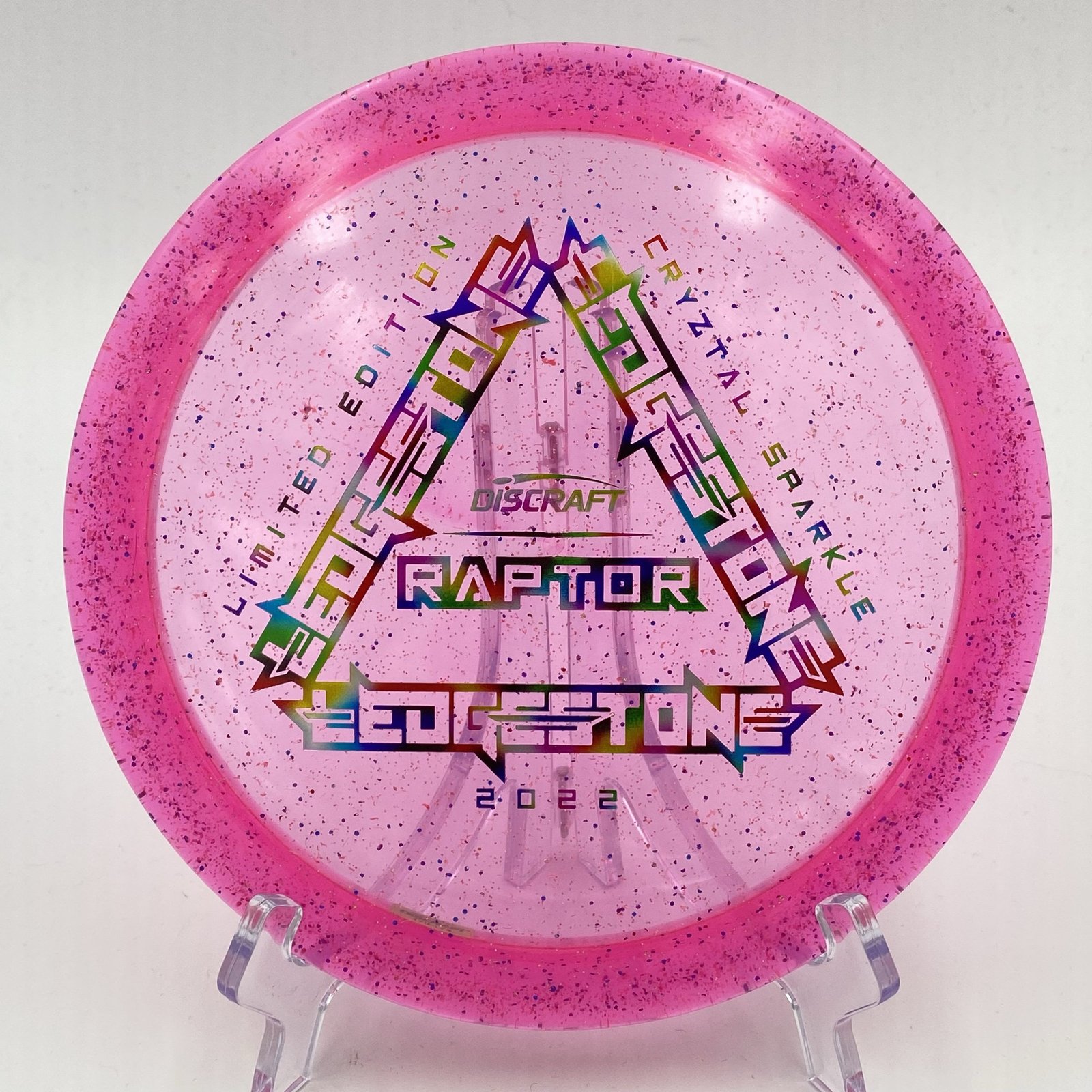 Top view of vibrant pink Discraft CryZtal Sparkle Raptor - 2022 Ledgestone Limited Edition with unique foil stamp.