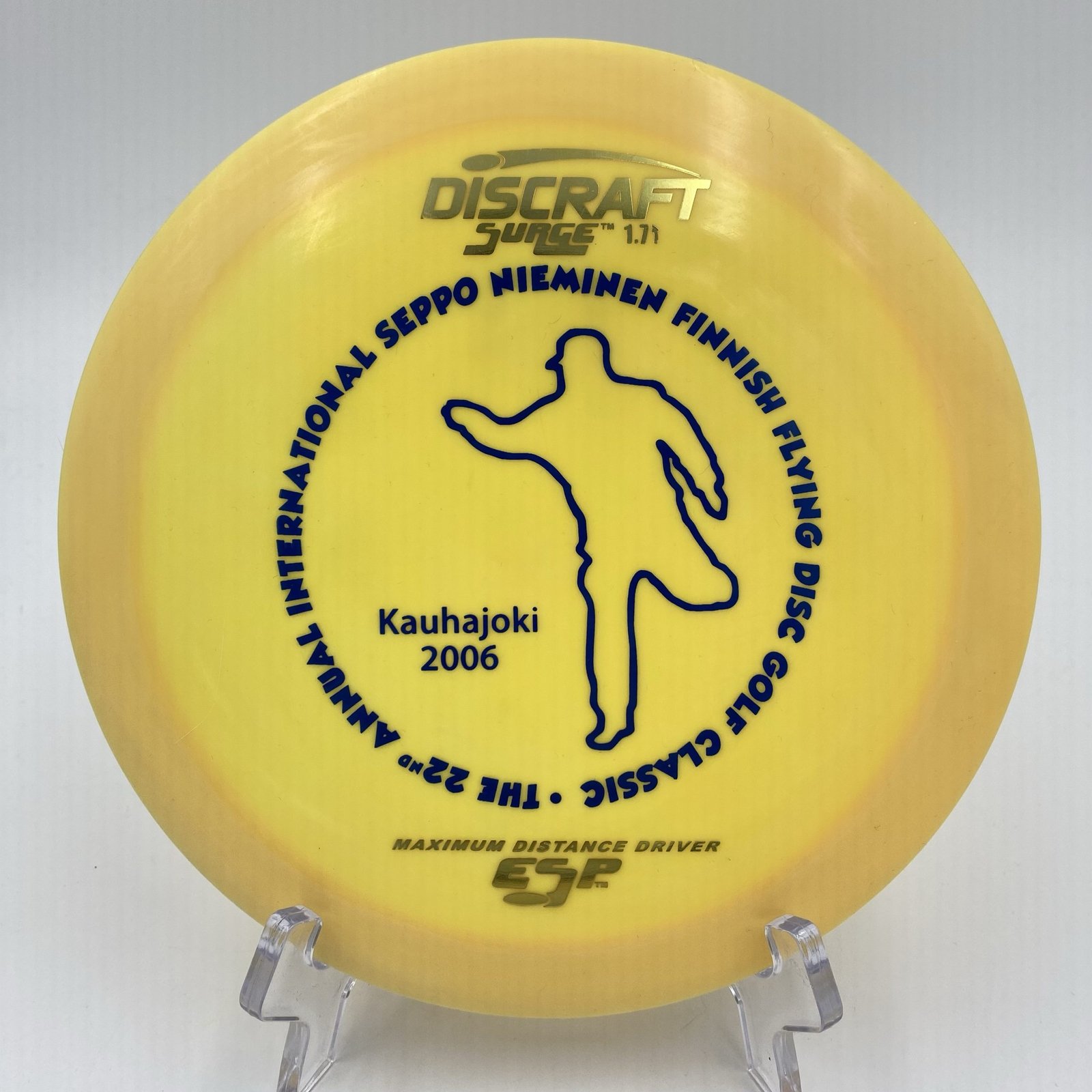 Top view of the special edition Discraft ESP Surge in vibrant colors commemorating the 22nd Annual International Seppo Nieminen Finnish Flying Disc Golf Classic.