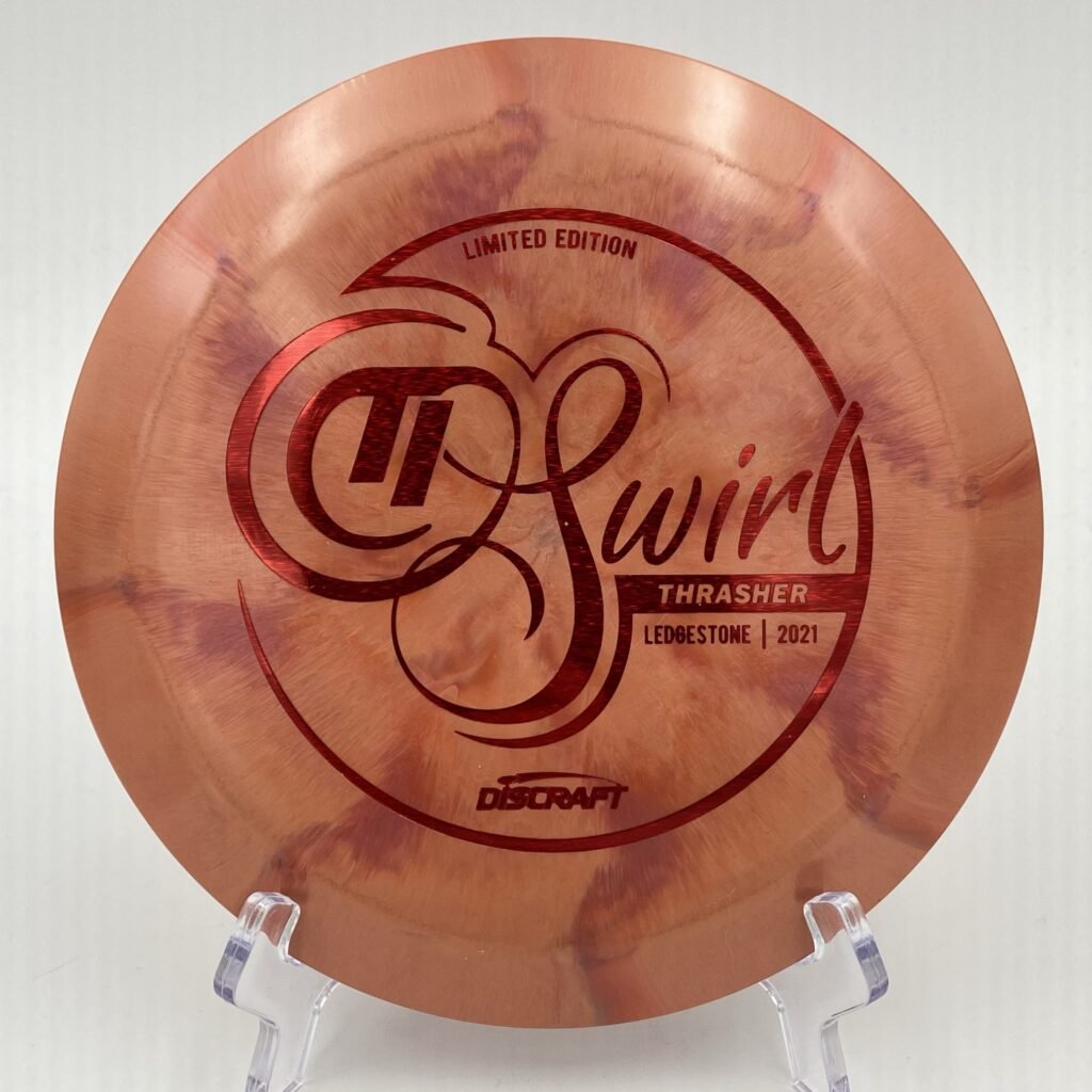 Top view of vibrant orange Discraft Thrasher in CryZtal Sparkle plastic - 2021 Ledgestone Edition with silver foil stamp.