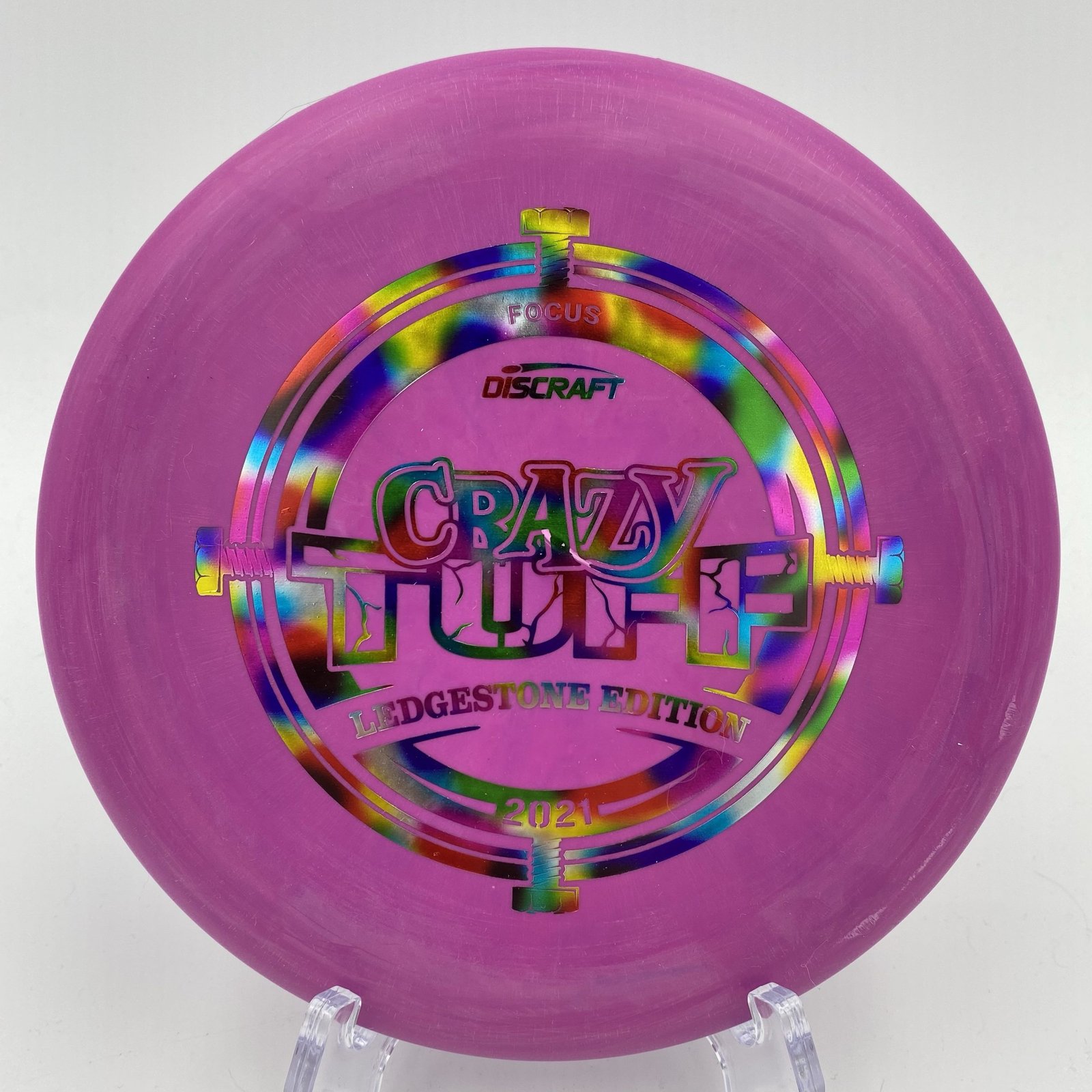 Top view of vibrant purple Discraft Focus in Crazy Tuff plastic - 2021 Ledgestone Edition with distinctive foil stamp.