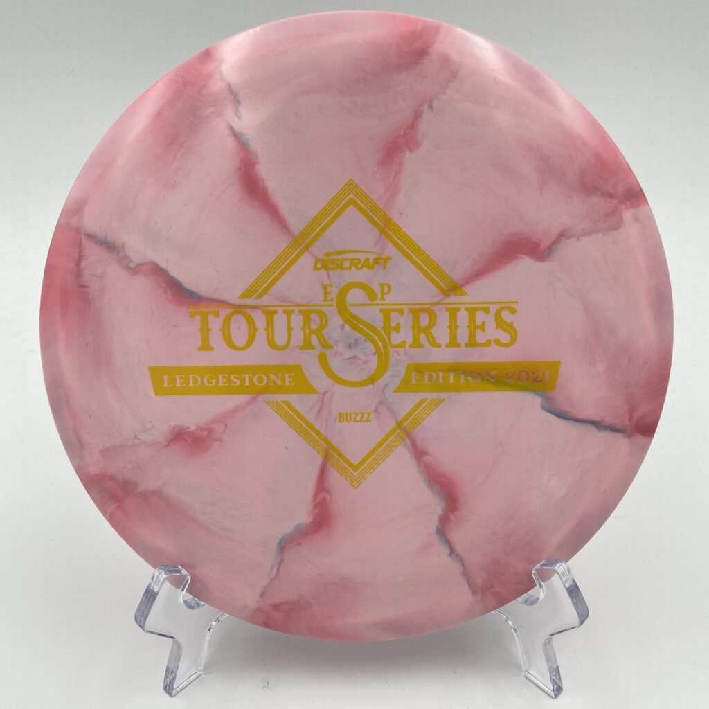 Top view of light pink Discraft Buzzz in ESP Swirl plastic - 2021 Ledgestone Tour Series with vibrant pink swirl.