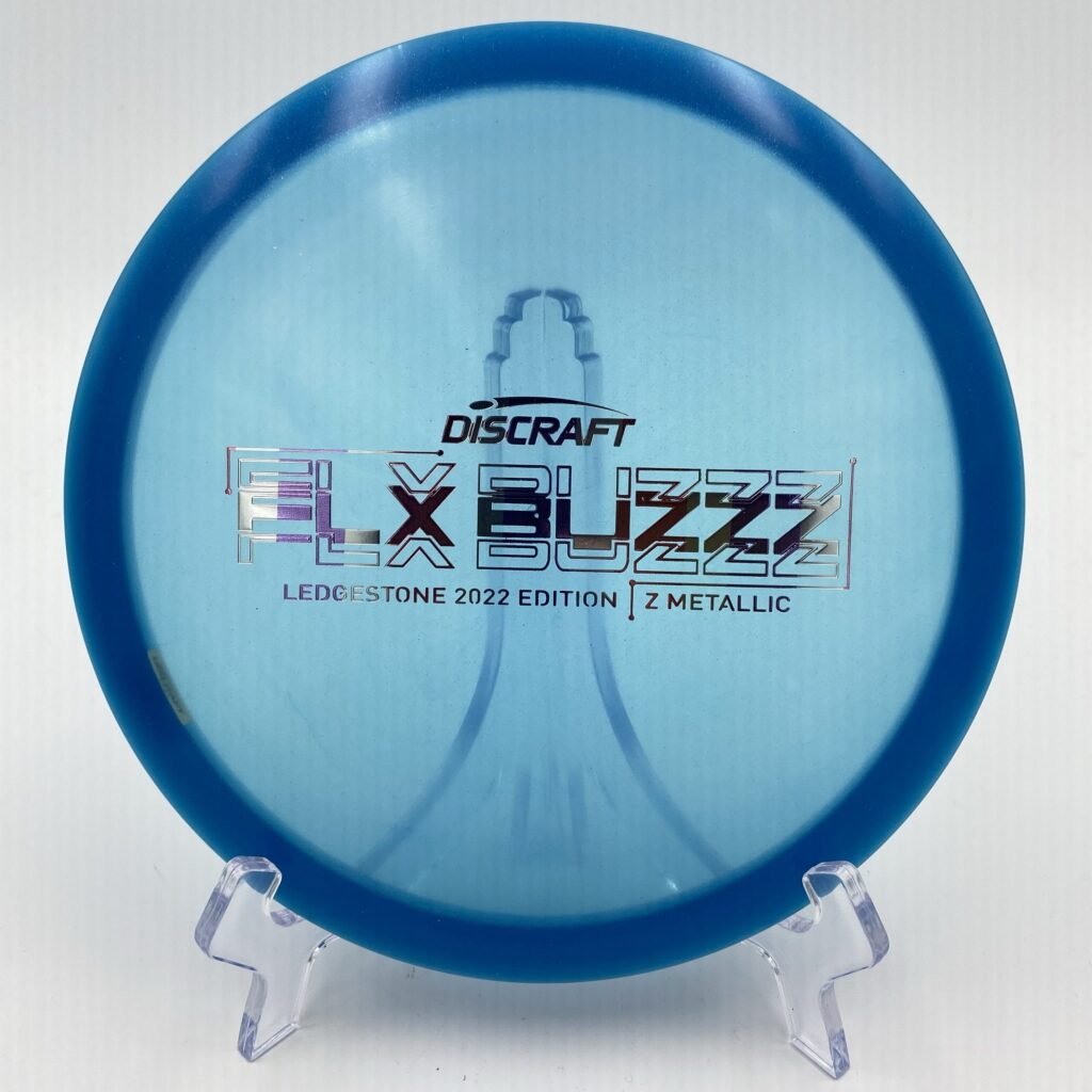 Top view of translucent Discraft Z Metallic FLX Buzzz in 2022 Ledgestone Edition with vibrant foil stamp.