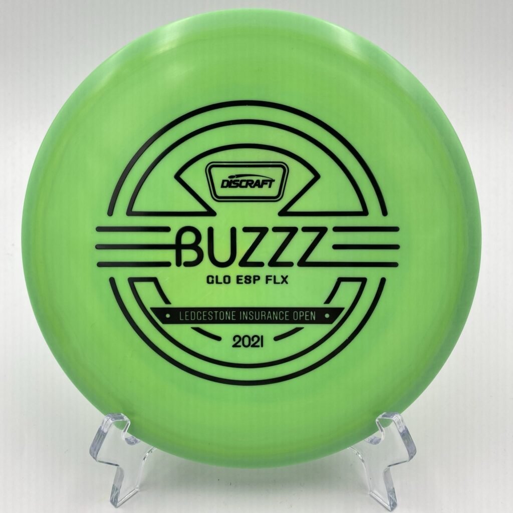 Top view of glowing green Discraft Buzzz in ESP FLX plastic - 2021 Ledgestone Edition with holographic foil stamp.