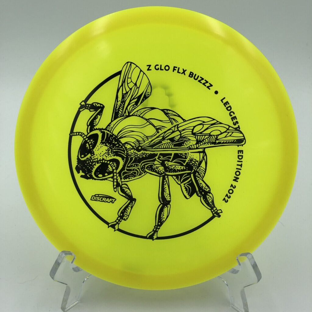 Top view of bright green Discraft Z Glo FLX Buzzz in 2022 Ledgestone Edition plastic with shimmering glow effect.