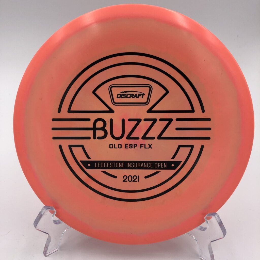 Top view of glowing green Discraft Buzzz in Glo ESP plastic - 2021 Ledgestone Insurance Open edition.