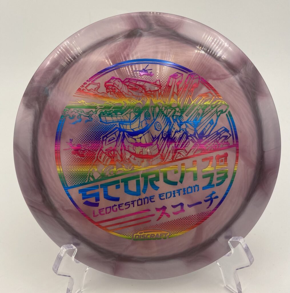 Top view of orange and black Discraft Scorch in Titanium plastic - 2023 Ledgestone Edition with vibrant swirl pattern.