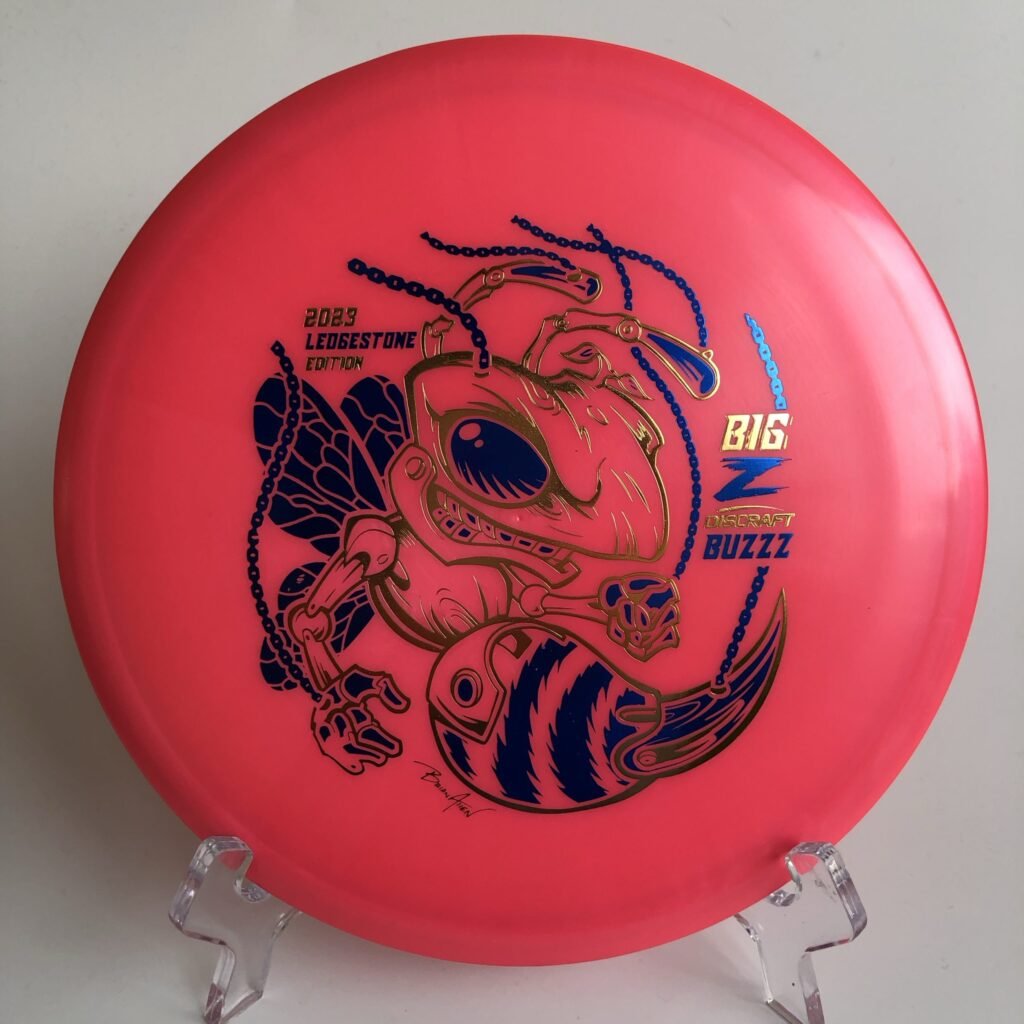Top view of green Discraft Buzzz in Big Z plastic - 2023 Ledgestone Edition with colorful foil stamp.