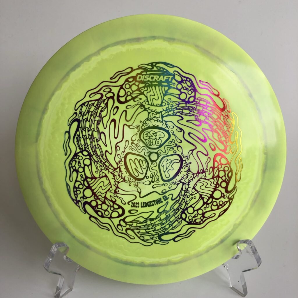 Top view of vibrant orange Discraft Nuke in ESP Glo plastic - 2023 Ledgestone Edition with holographic foil stamp.