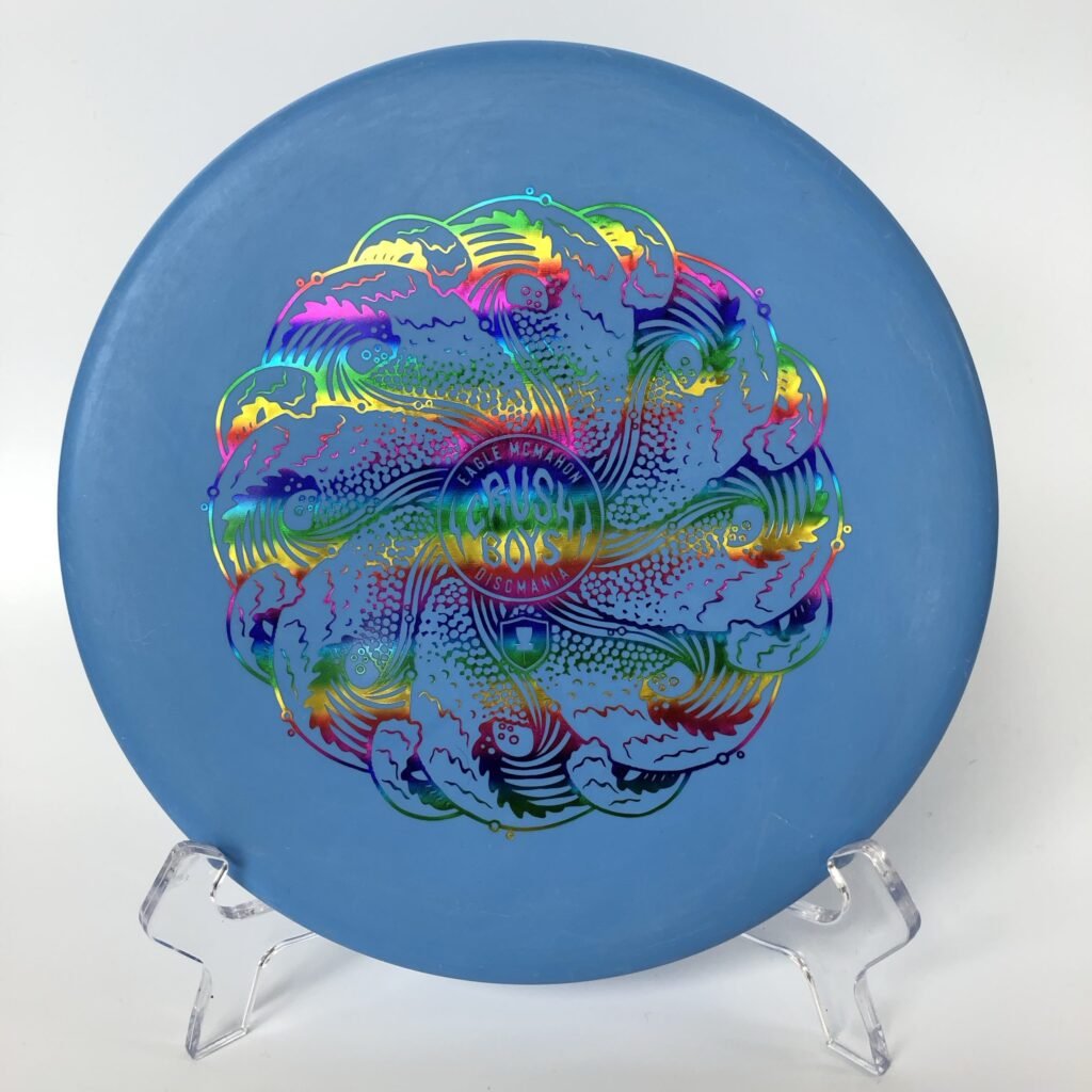 Top view of blue Discmania Hard Exo Tactic - Eagle McMahon Crushboys with vibrant artwork.