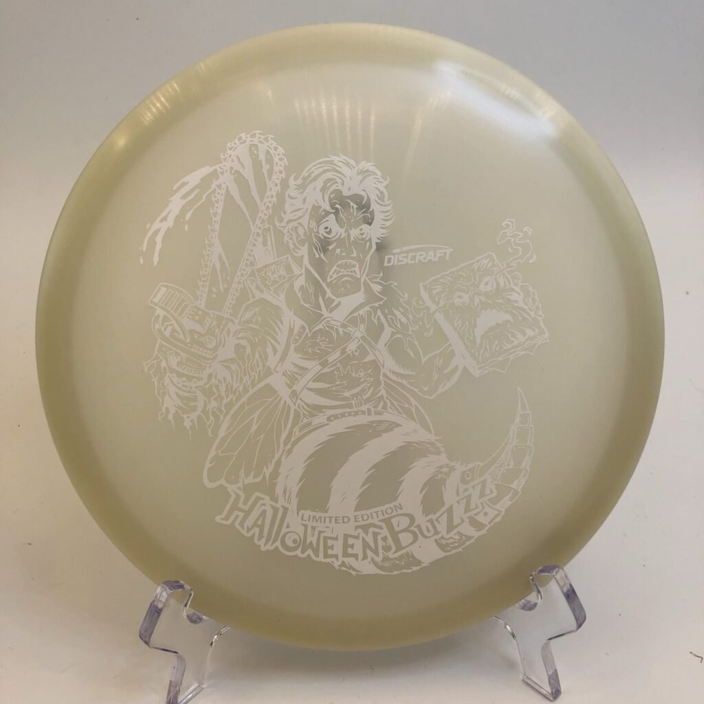 Top view of glowing green Discraft Buzzz in Z Nite Glo plastic Halloween 2023 edition.