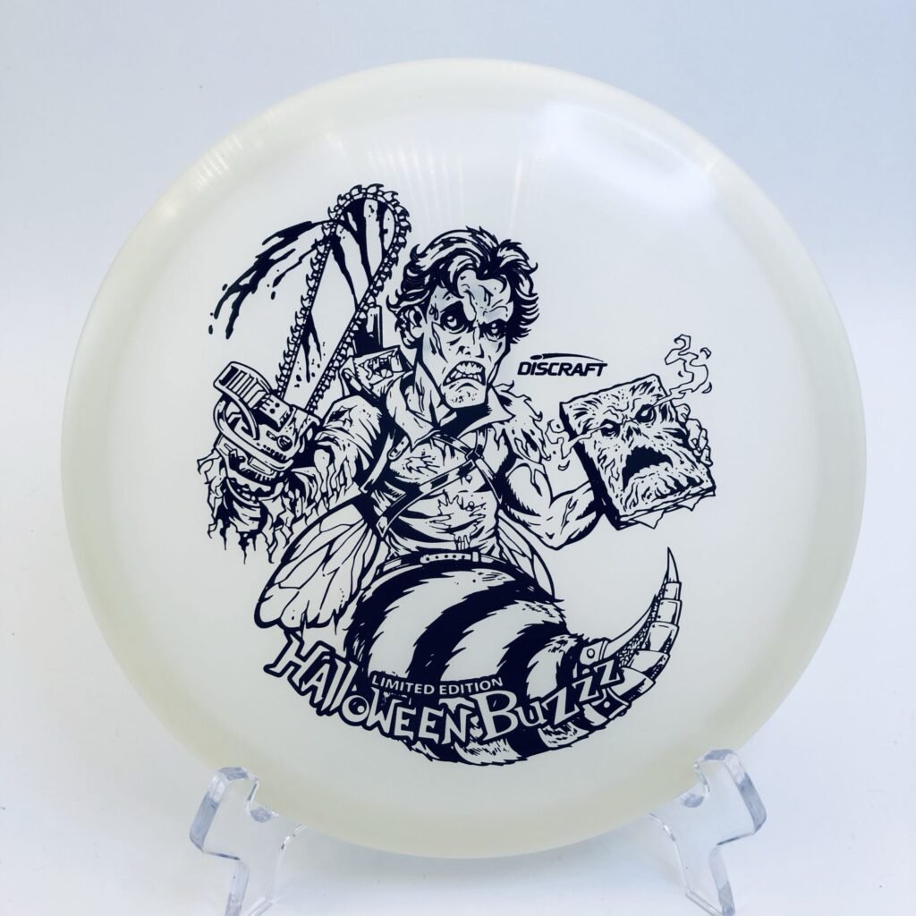 Top view of luminous orange Discraft Buzzz in Nite Glo plastic - 2023 Halloween Edition.