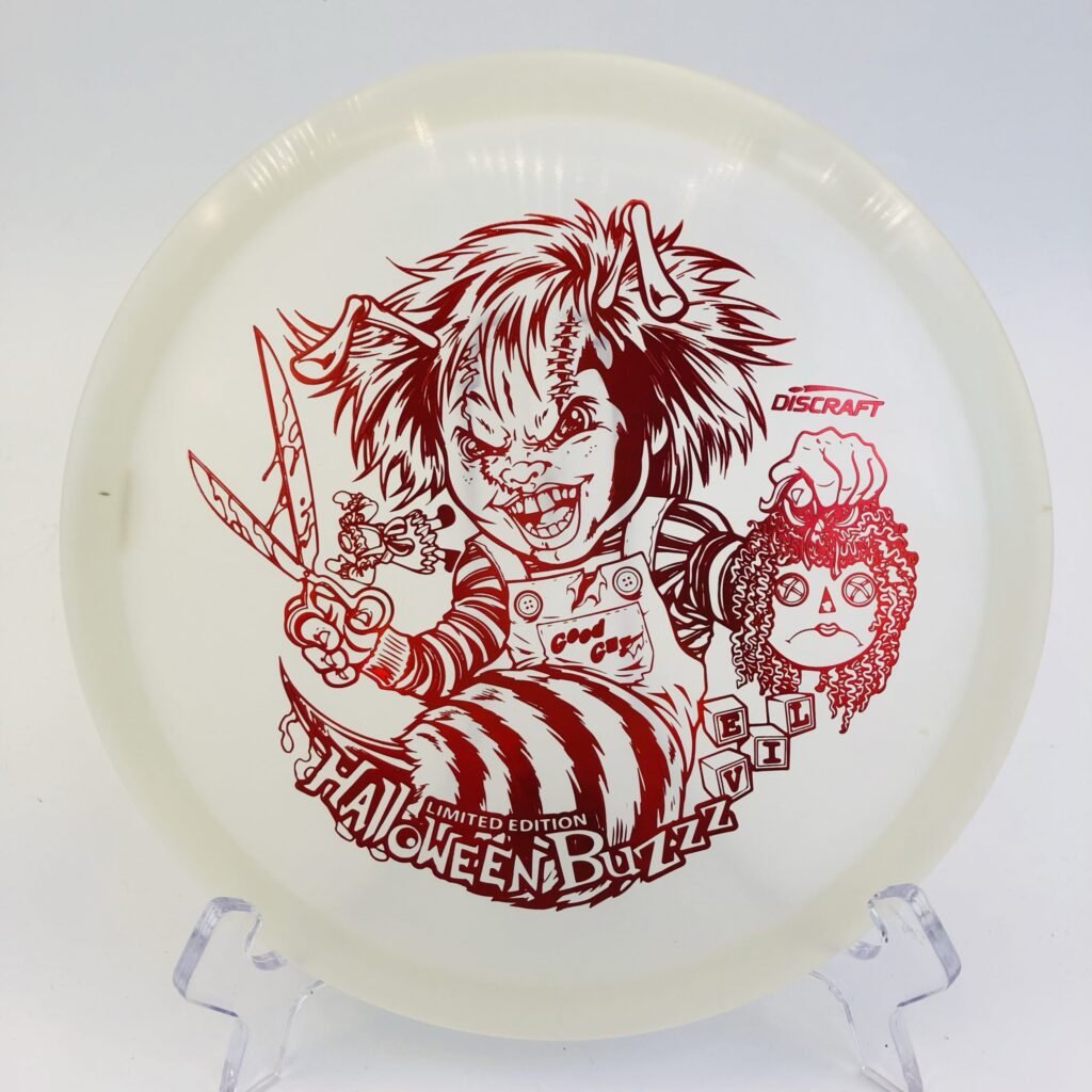 Top view of glowing green Discraft Buzzz in Z Nite Glo plastic - 2022 Halloween Special Edition with detailed artwork.
