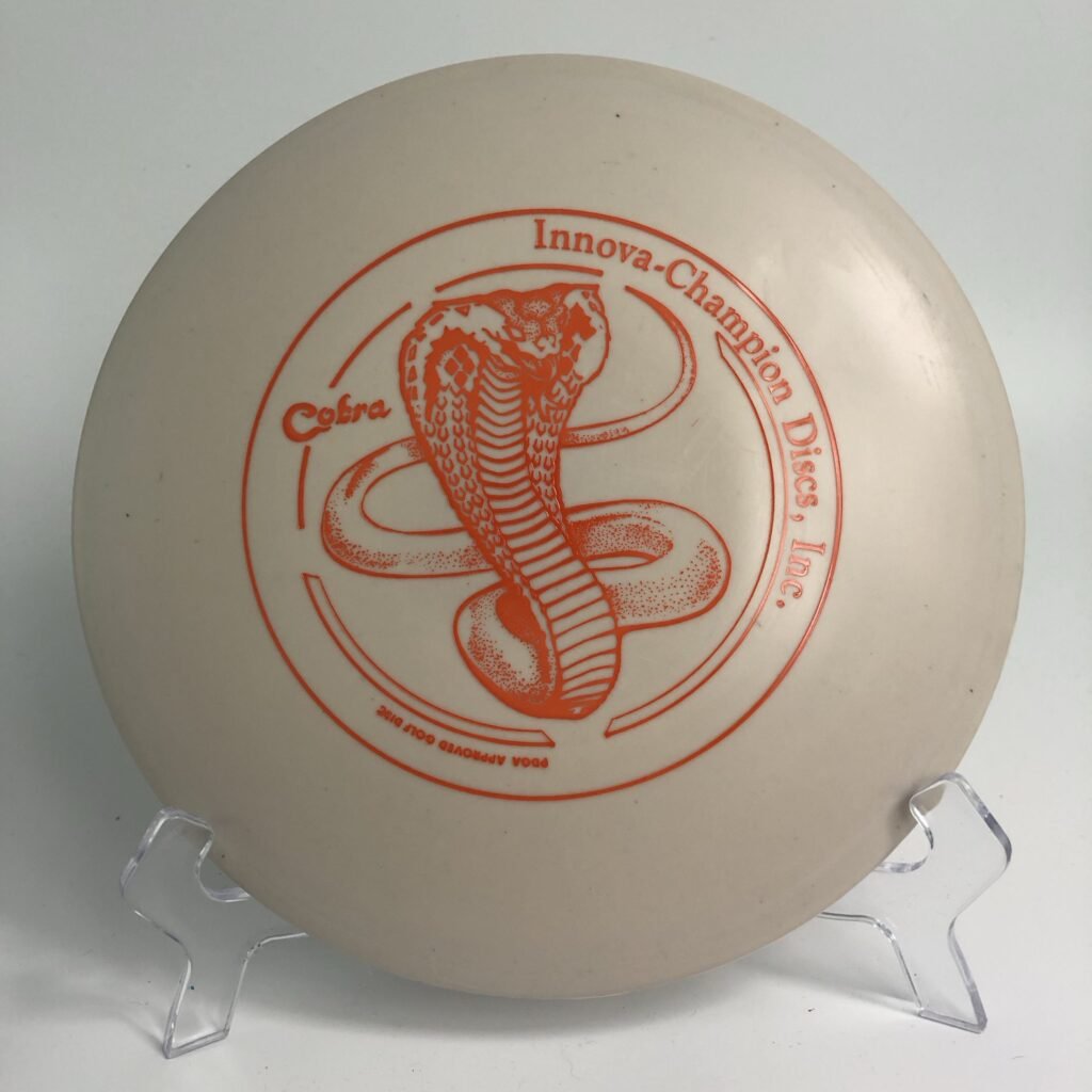 Top view of orange Innova DX Cobra in Circle Stamp design.