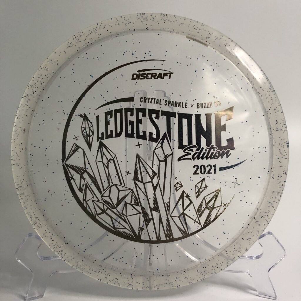 Top view of translucent blue Discraft CryZtal FLX Sparkle Buzzz - 2021 Ledgestone Edition with silver foil stamp.