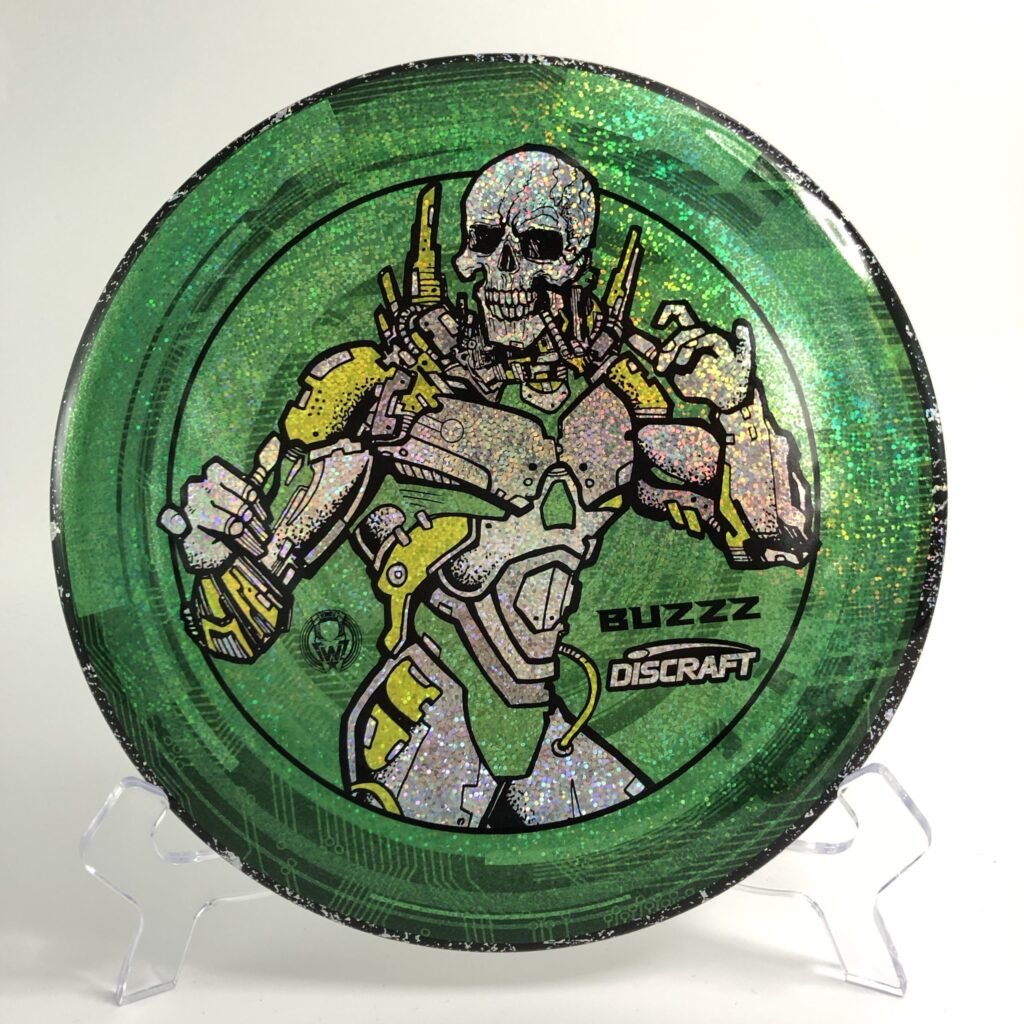 Main view of white Discraft Buzzz in ESP plastic featuring a Les White skeleton robot design.