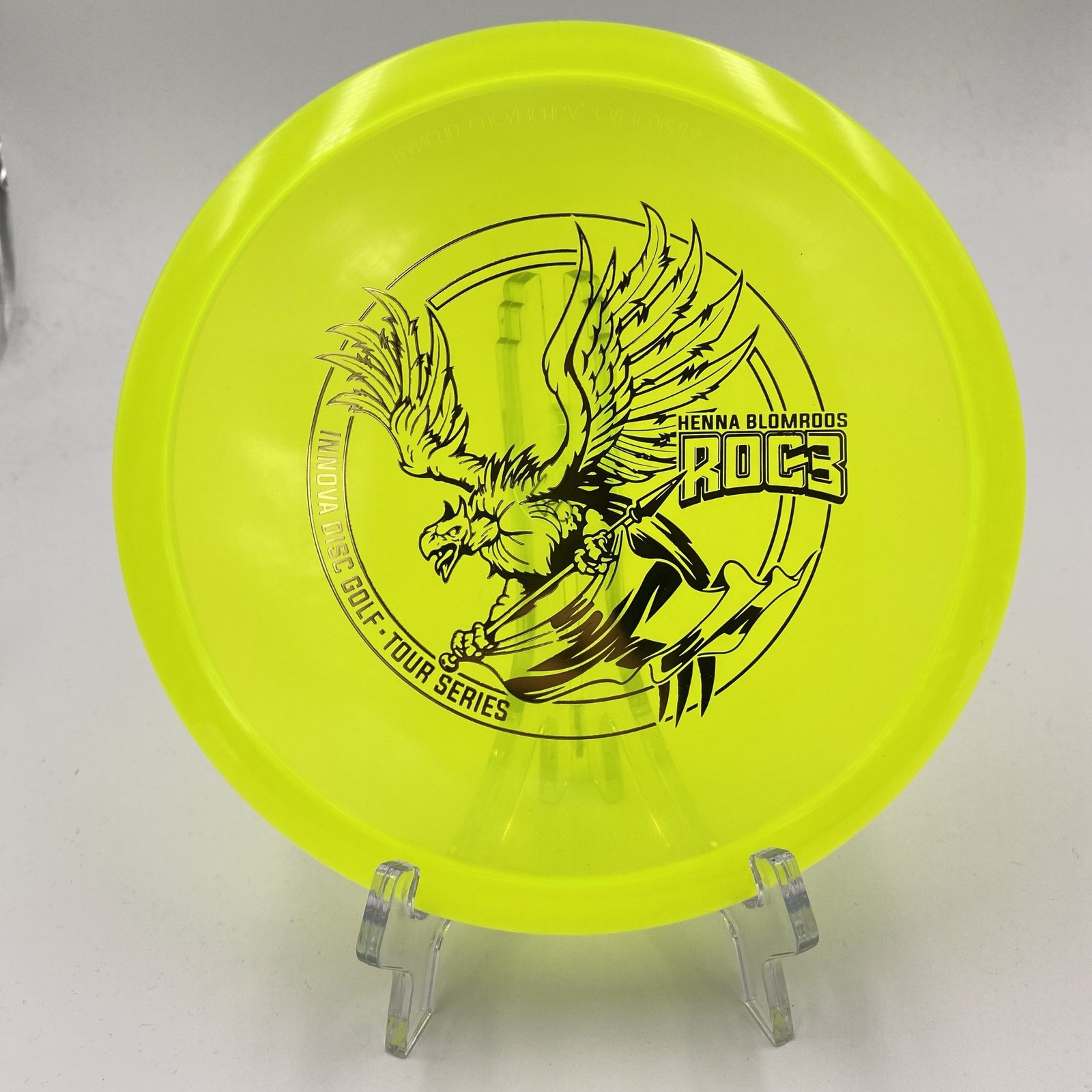 Top view of vibrant yellow Innova Roc3 in Champion plastic 2021 Tour Series with intricate henna design.