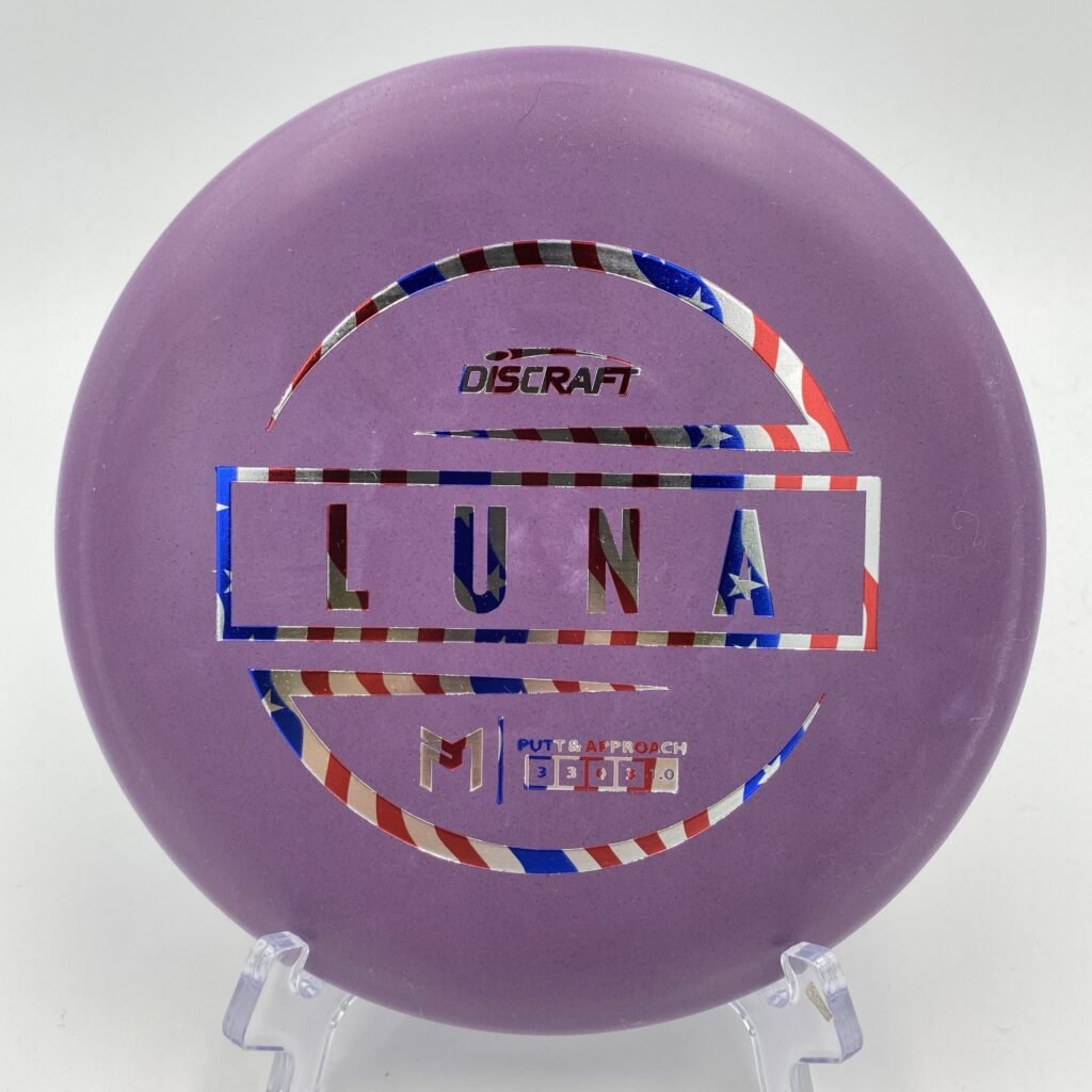 Top view of blue Discraft Luna in Base plastic with 6x Paul McBeth stamp.