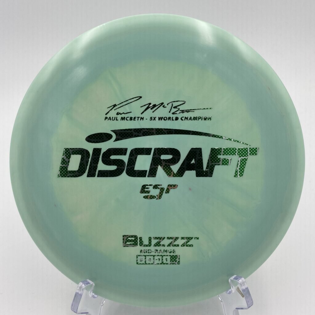 Top view of multicolored Discraft Buzzz in ESP plastic featuring 5x Paul McBeth signature.