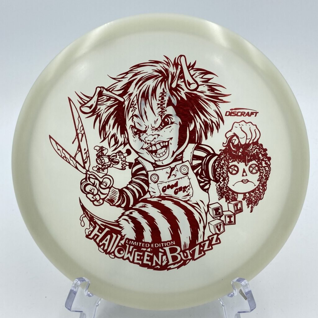 Top view of glowing green Discraft Z Nite Glo Buzzz in specially designed Halloween 2022 'Killer Doll' edition.