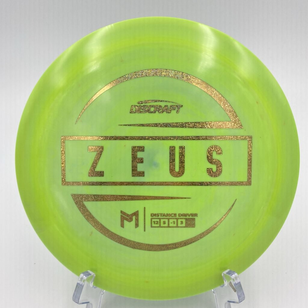 Top view of bright blue Discraft ESP Zeus - 6x Paul McBeth Edition disc with silver foil stamp.