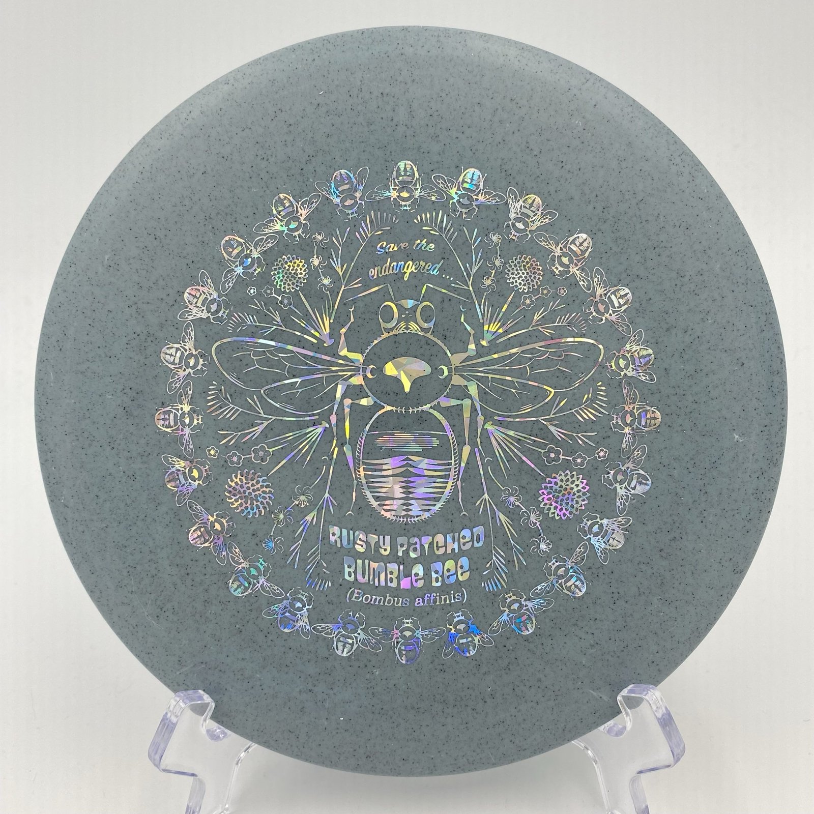 Top view of translucent Rubber Blend Discraft Buzzz SS in a special Rusty Patched Bumble Bee design.