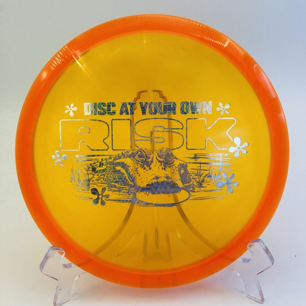 Discraft Buzzz in CryZtal FLX plastic - Disc at Your Own Risk edition with vibrant color.